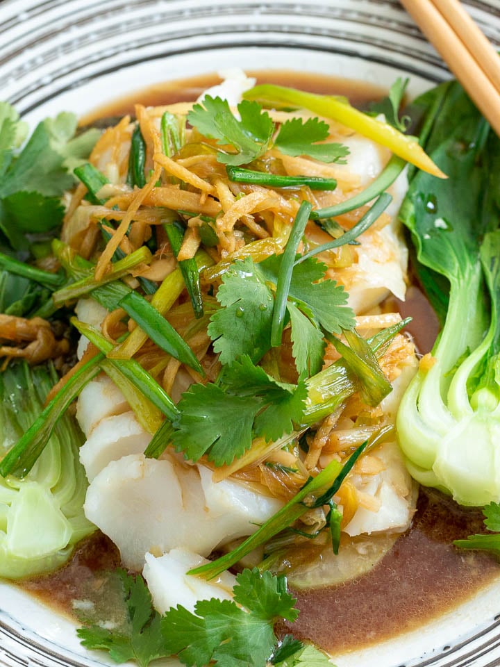 Plated Asian Steamed Fish garnished with fresh cilantro.