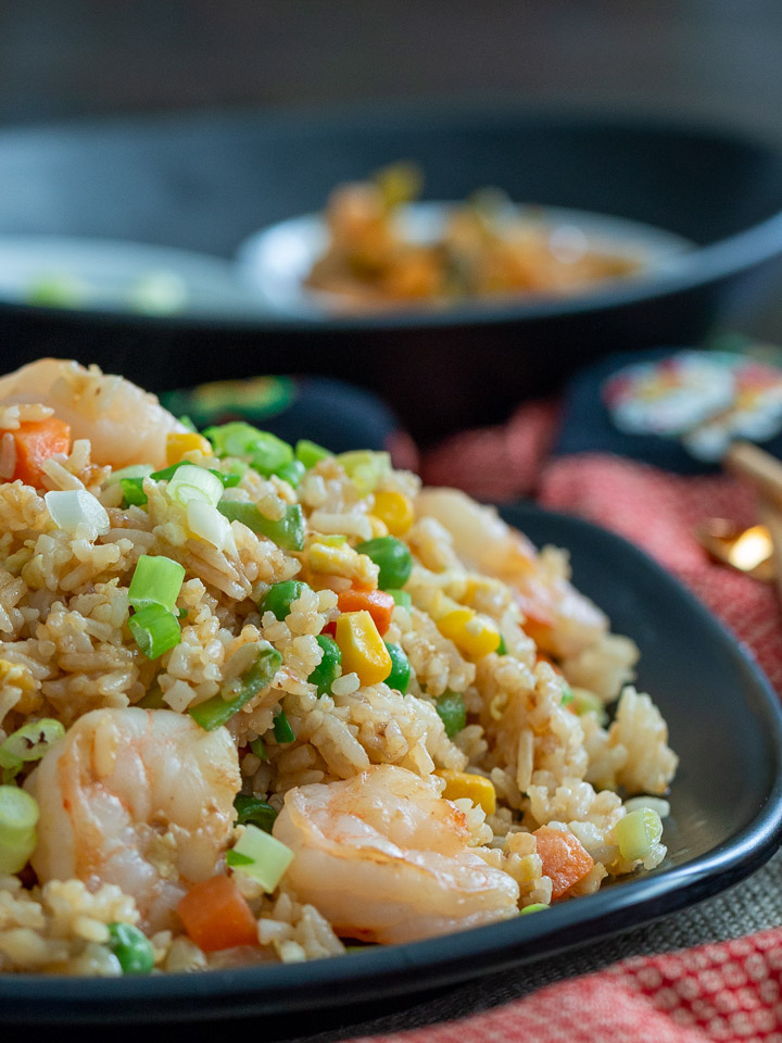 Huge bowl to share of fried rice displayed with Chinese New Year cloths.