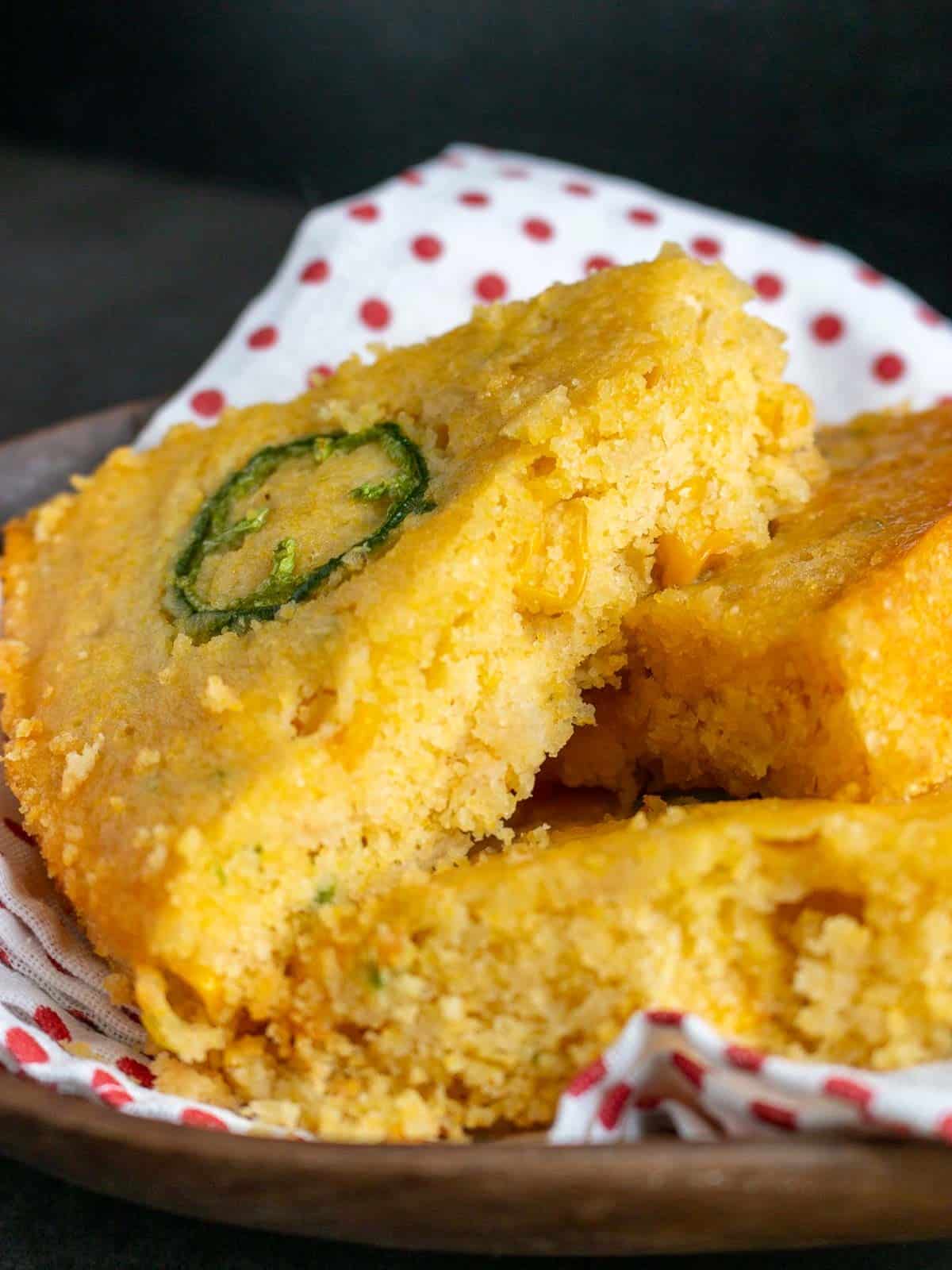 Sliced of corn bread in a basket ready for the dinner table. 