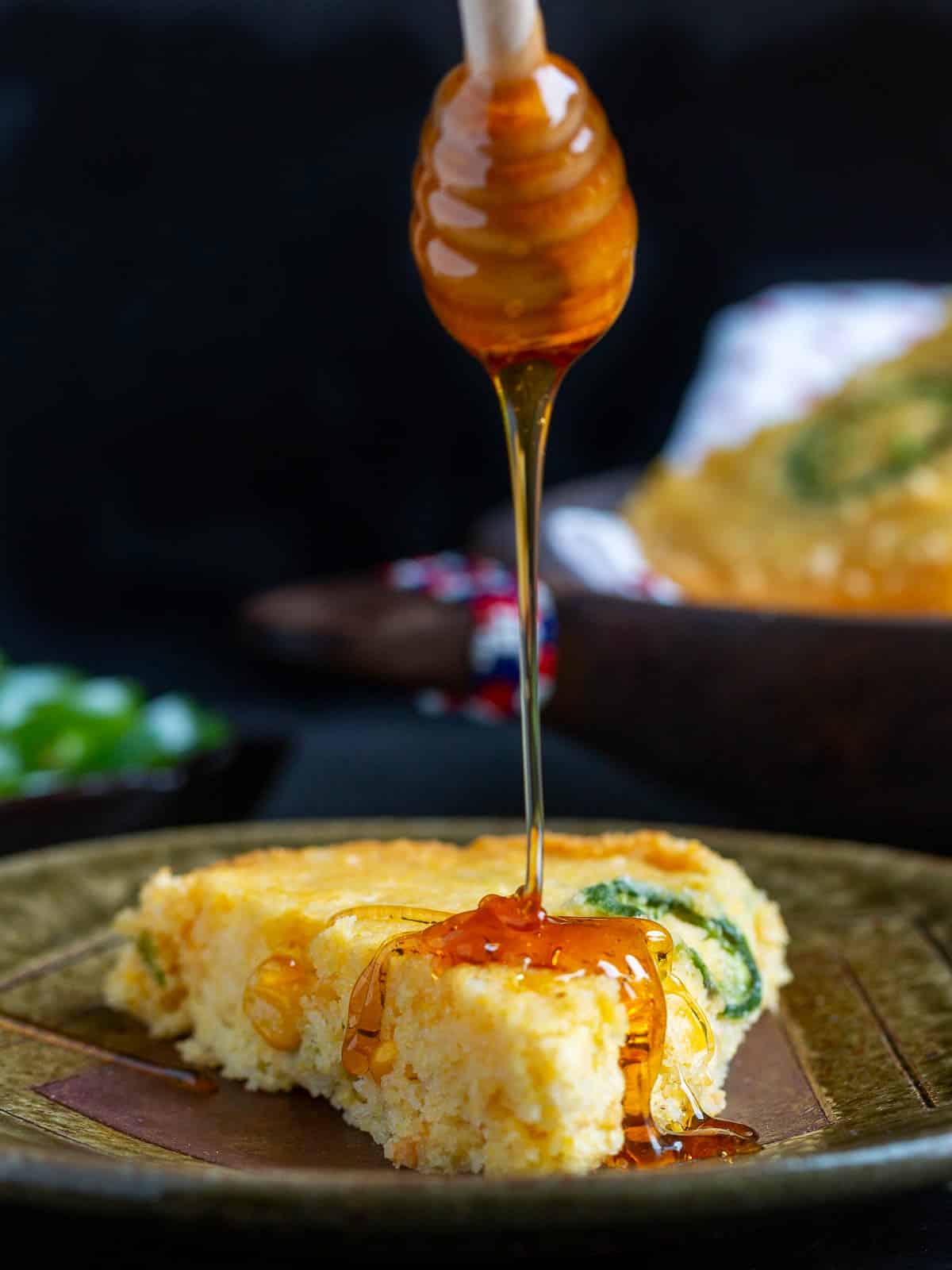 Honey drizzled over a slice of air fryer cornbread. 