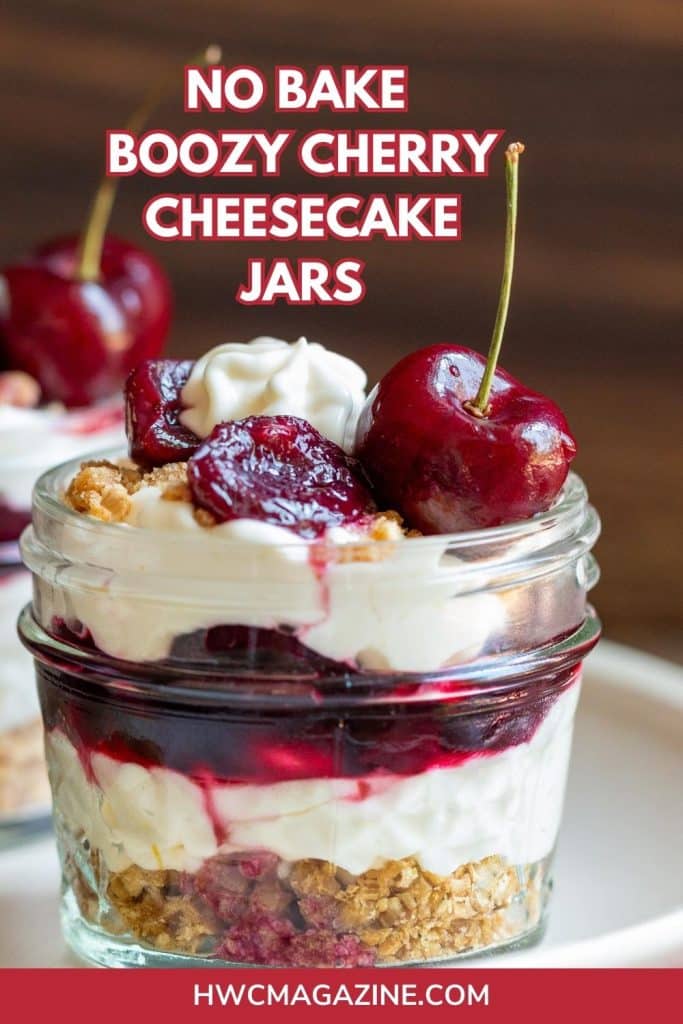 3 no bake boozy cherry cheesecake jars topped with bourbon cherry compote on a white plate.