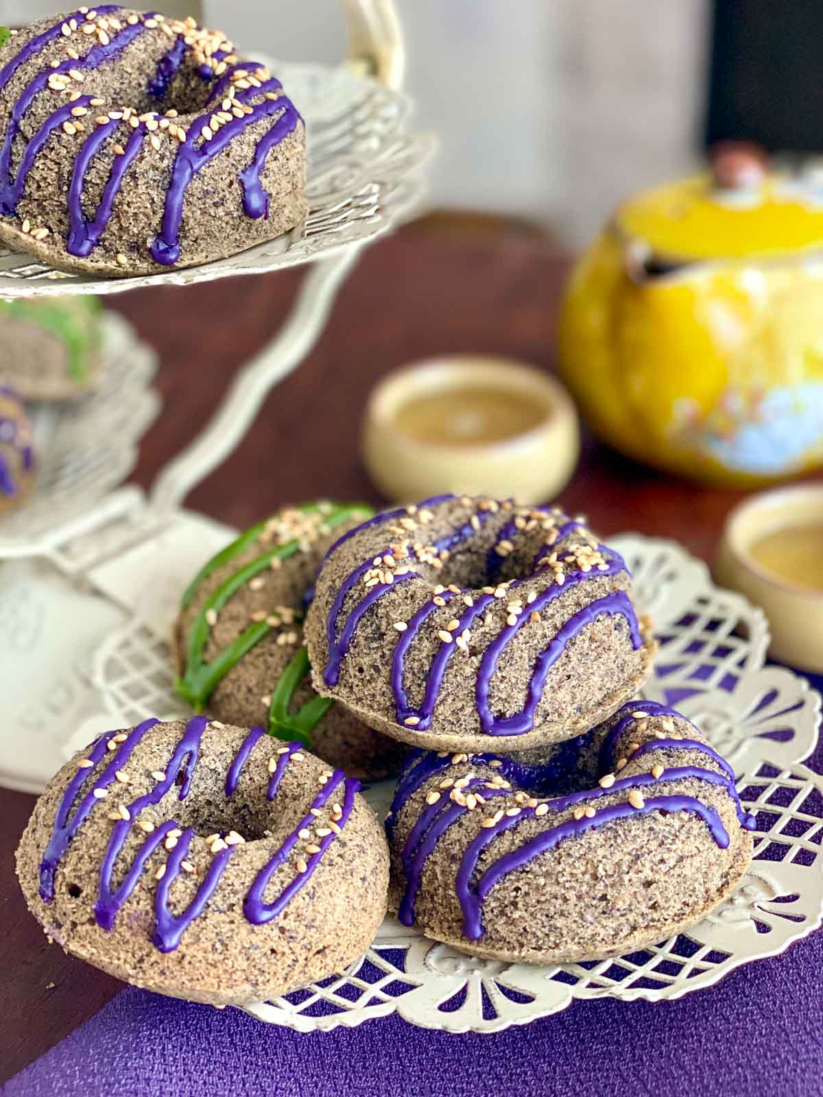 Teatime with black sesame mochi donuts and a yellow teapot. 