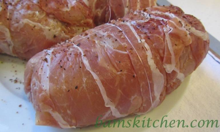 Chicken wrapped up is prosciutto and tied up with unflavored dental floss.
