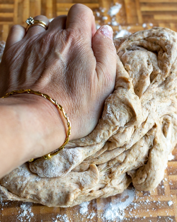 Kneading dough on a cutting board.