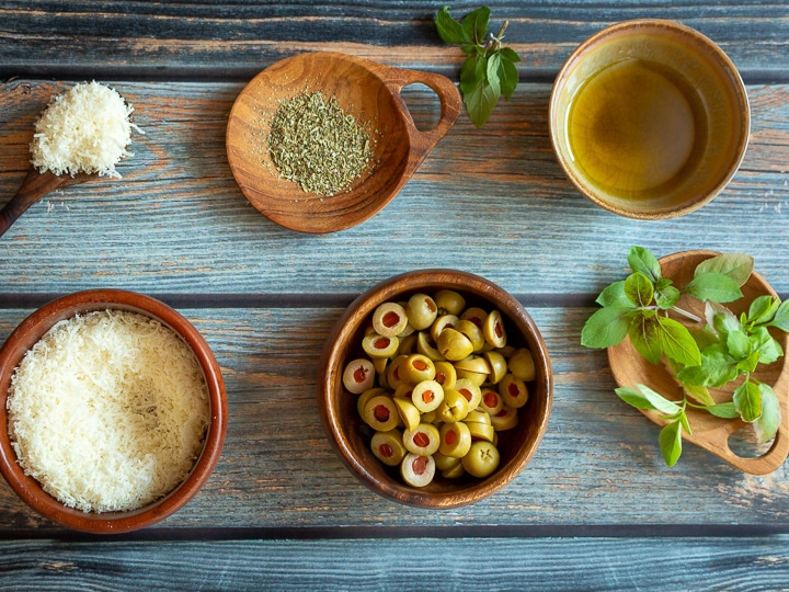 Our favorite toppings; olives, parmesan, fresh herbs and dried herbs.