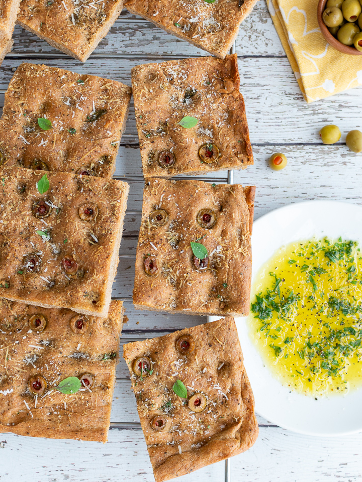 9 slices of focaccia bread with olives and herb dipping oil.