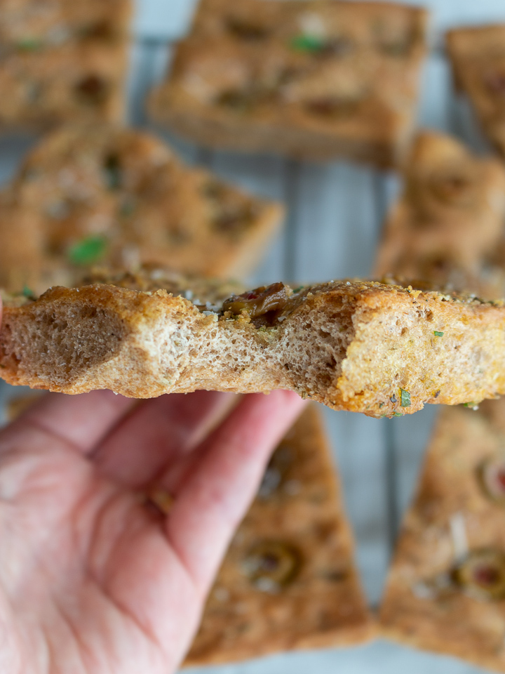 Bite out of a delicious slice of Whole Wheat Herb focaccia Bread. 