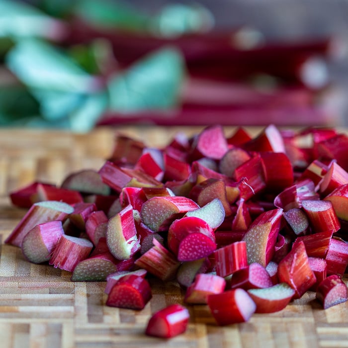 Chopped Rhubarb on a bamboo cutting board.