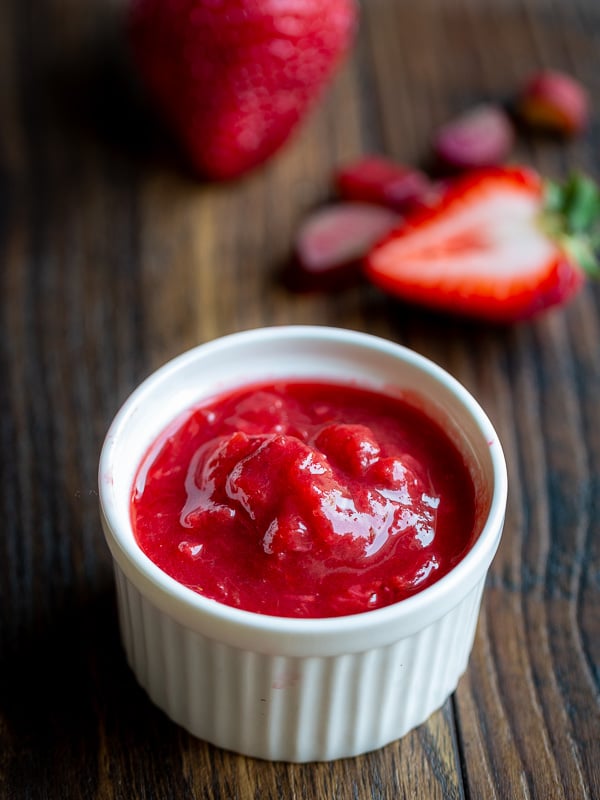 Closeup of a small white bowl with Strawberry Rhubarb refrigerator jam.