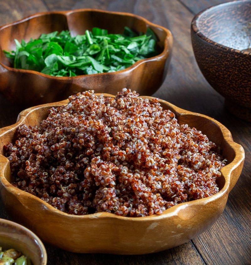 3 cups of cooked red quinoa in a wooden bowl.