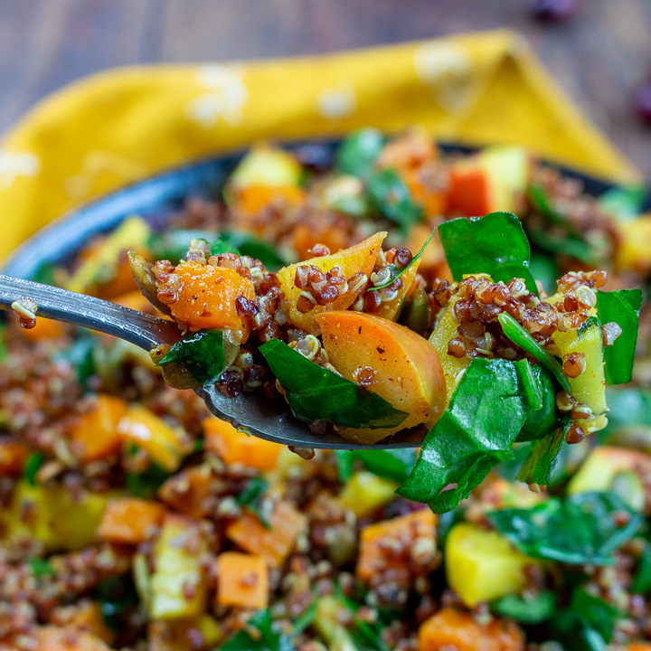 Bite shot of the delicious fall salad. Bright with turmeric and vegetables.