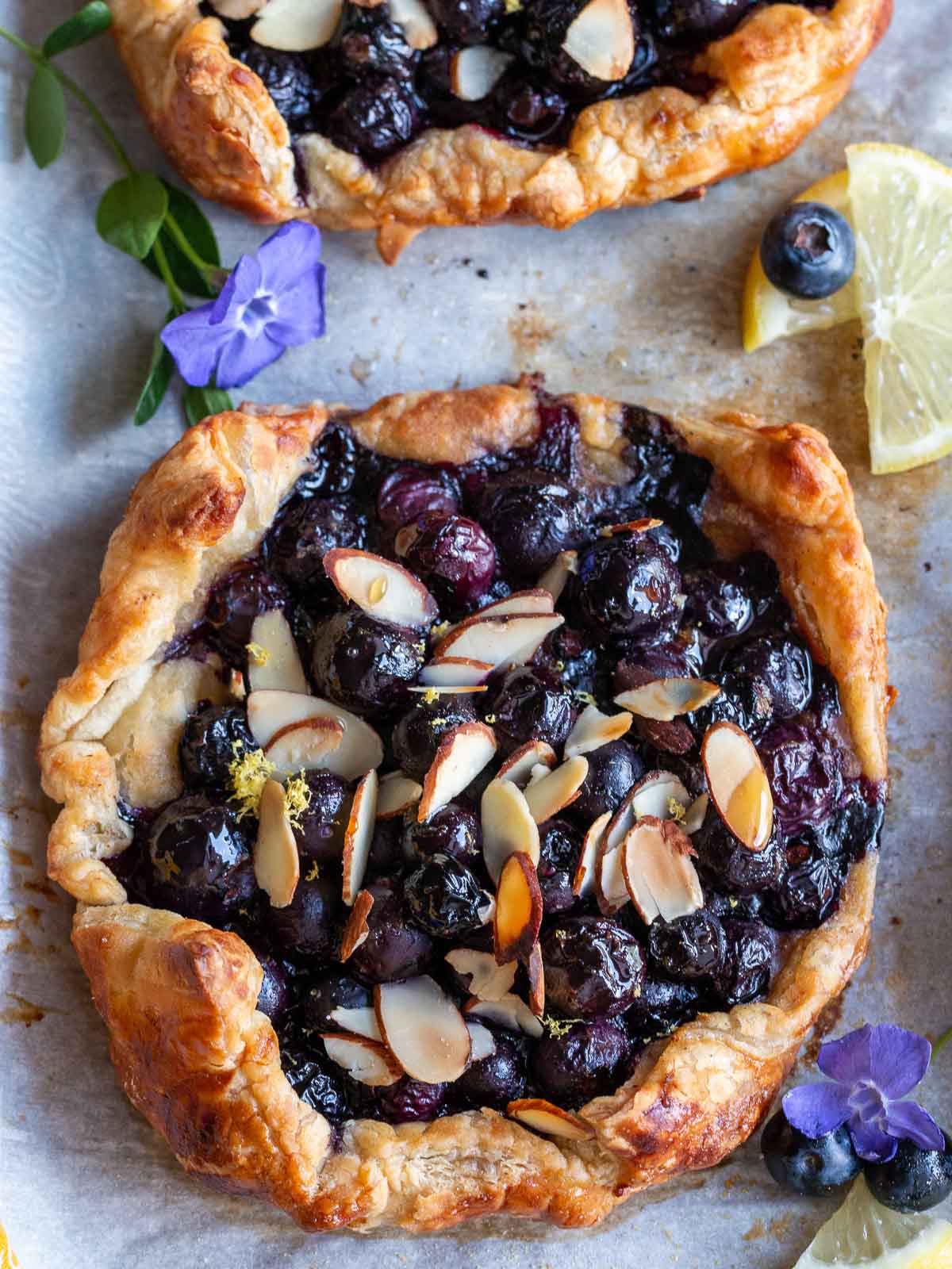 blueberry tart made with puff pastry showing the toasty almonds and bursting delicious blueberries.