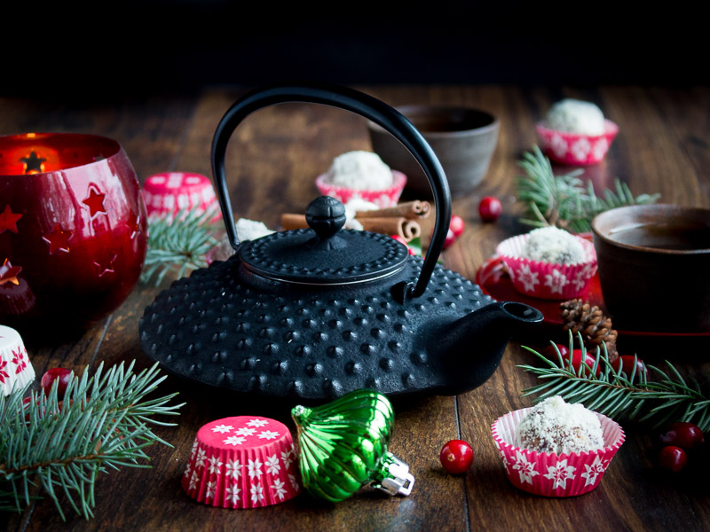Energy balls served with tea in a festive scene.