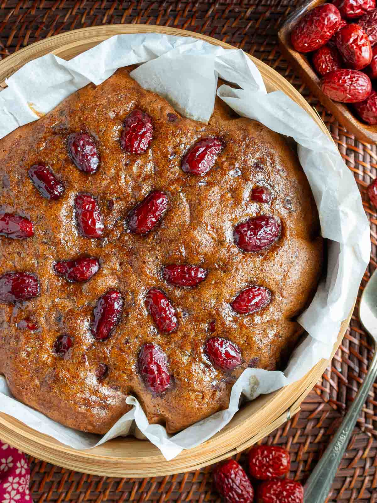 Steamed gingerbread date bread in a steamer basket studded with jujubes. 