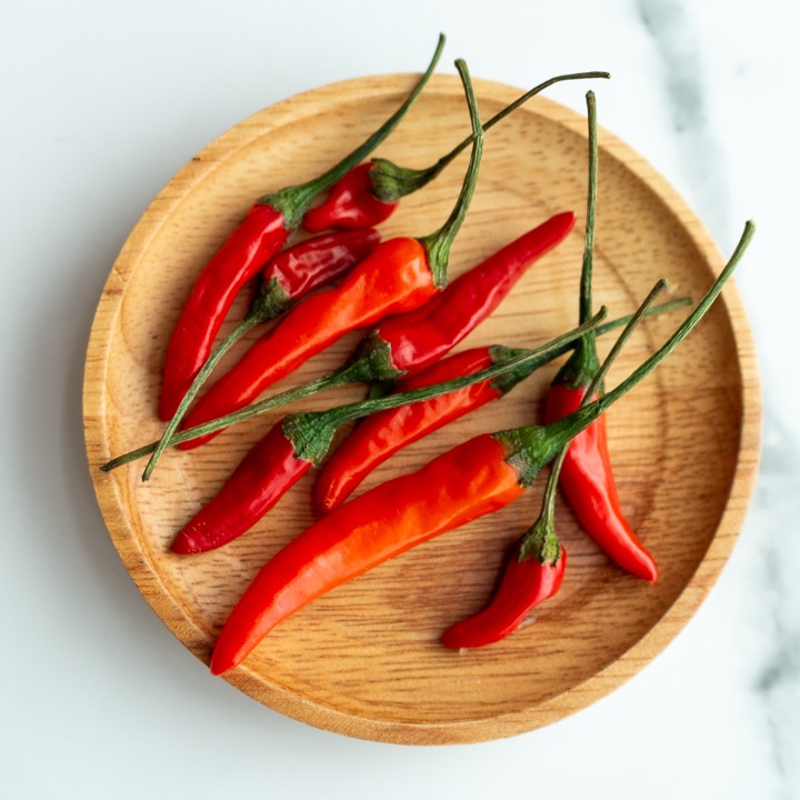 Thai bird chili on a wooden plate.