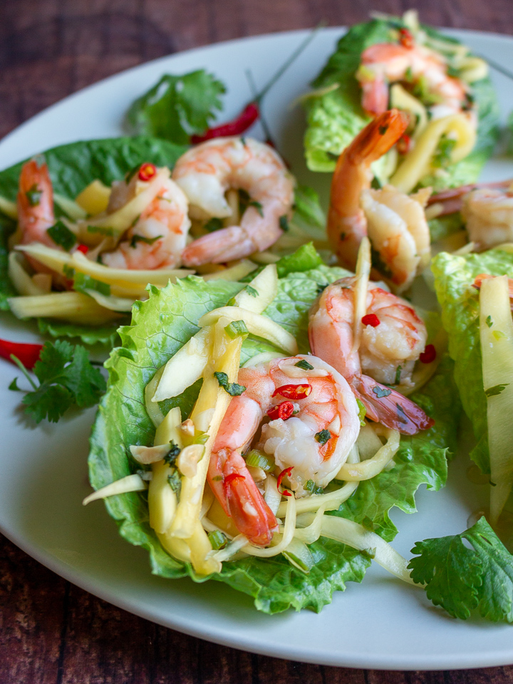 Spicy Shrimp and mangoes served in a lettuce wrap cup.