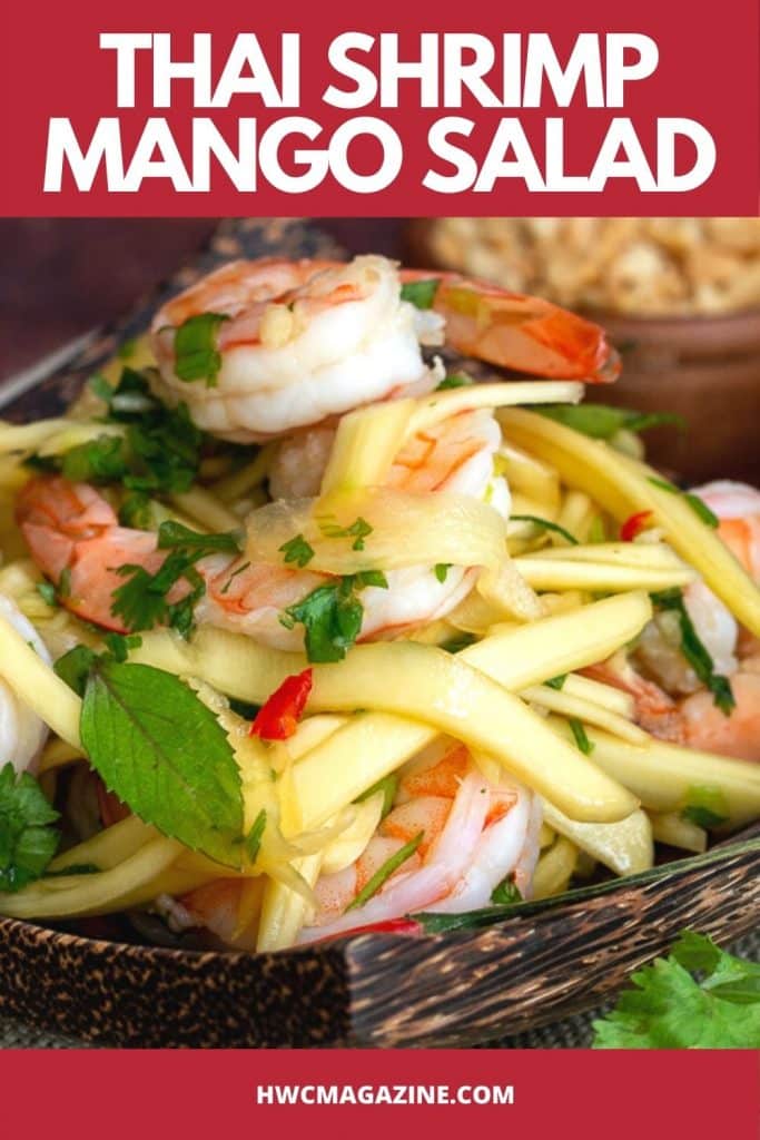 Thai Shrimp Green Mango Salad on a wooden plate.