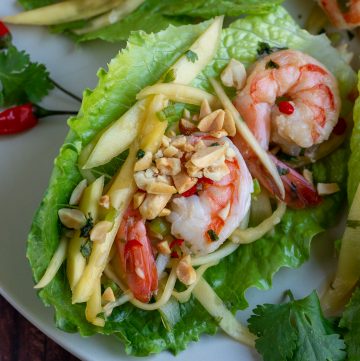 Thai Shrimp mango salad in a lettuce cup garnished with crushed peanuts.