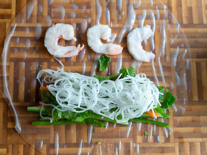 3 halved shrimp placed and 2 inches about the fresh vegetables with the pink side down.