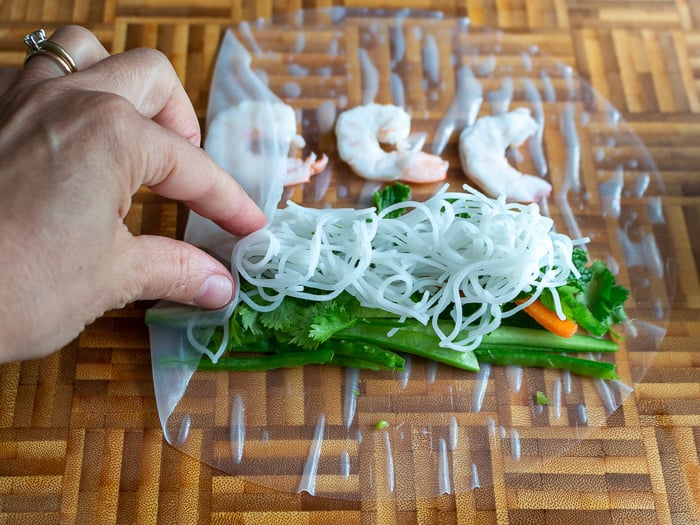 Folding over left side of the rice paper wrapper.