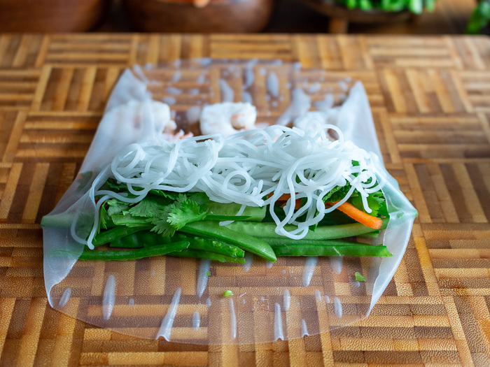 Folding over the right side of the rice paper wrapper.