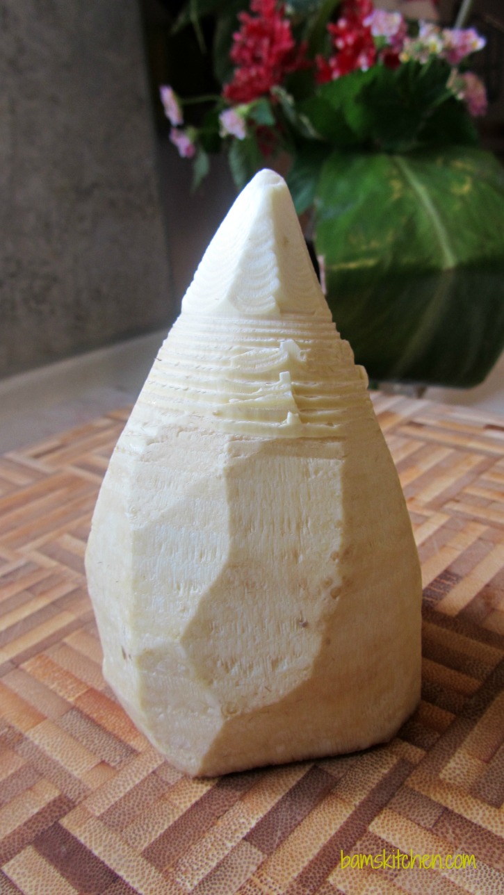 Freshly peeled bamboo whole on a cutting board. 