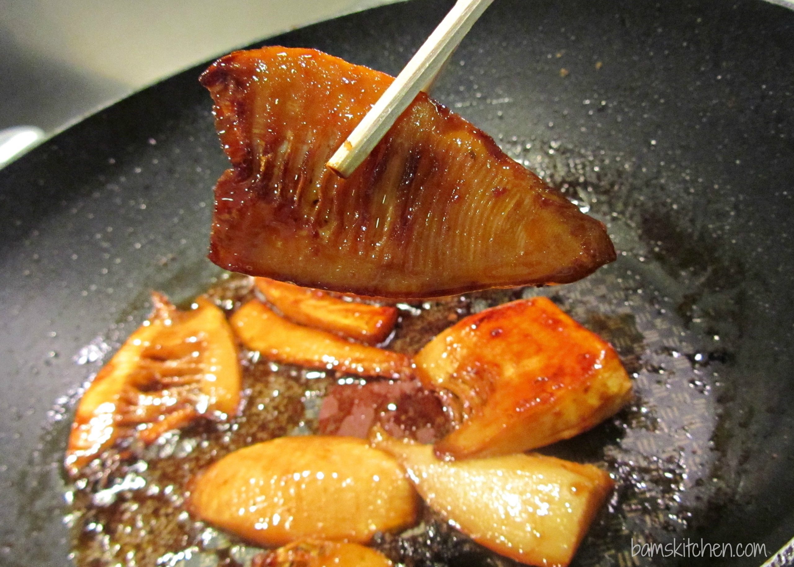 Bamboo shoots braising in a pan bronzed from the soy and brown sugar. 