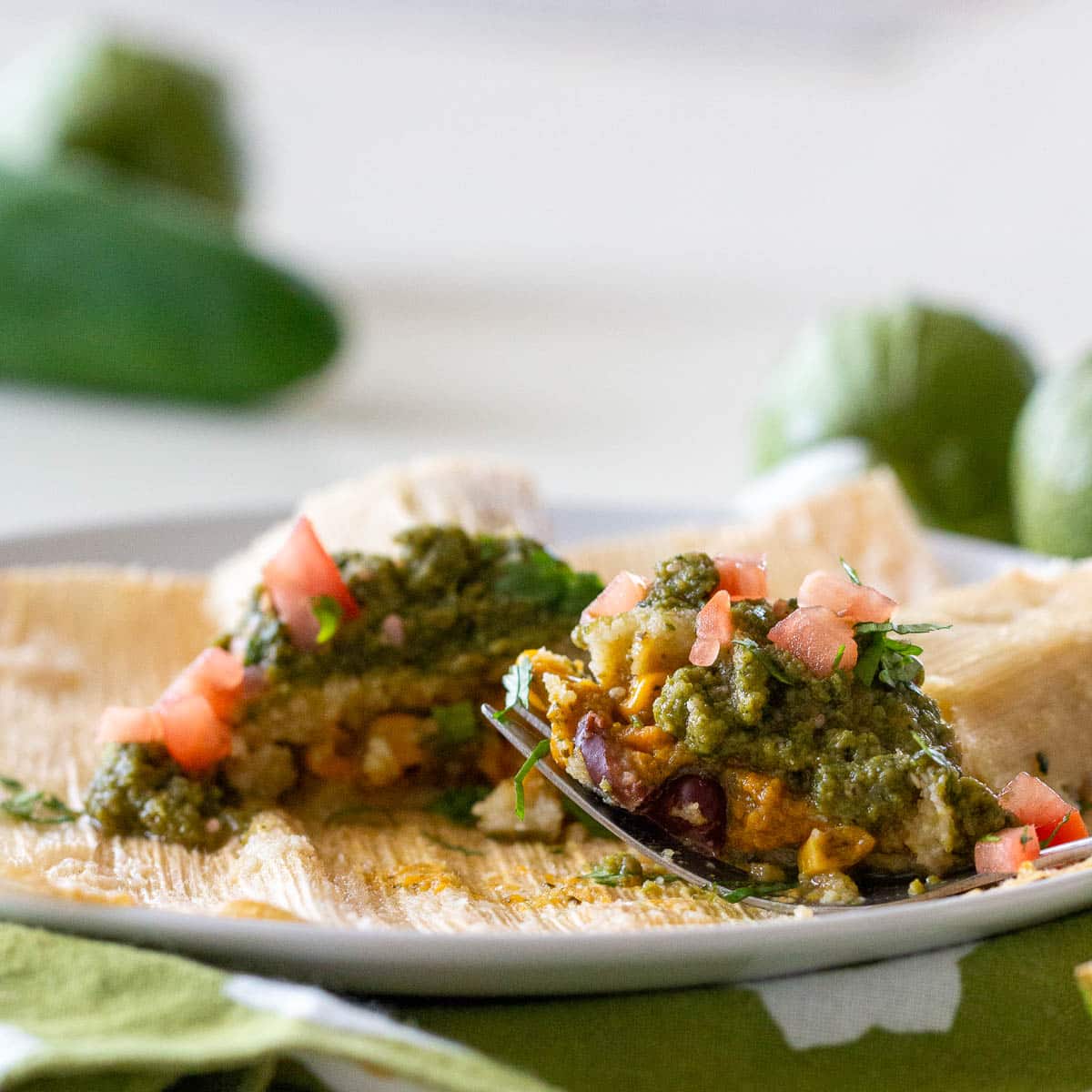 Taking a bite and showing the vegetarian tamale filling.