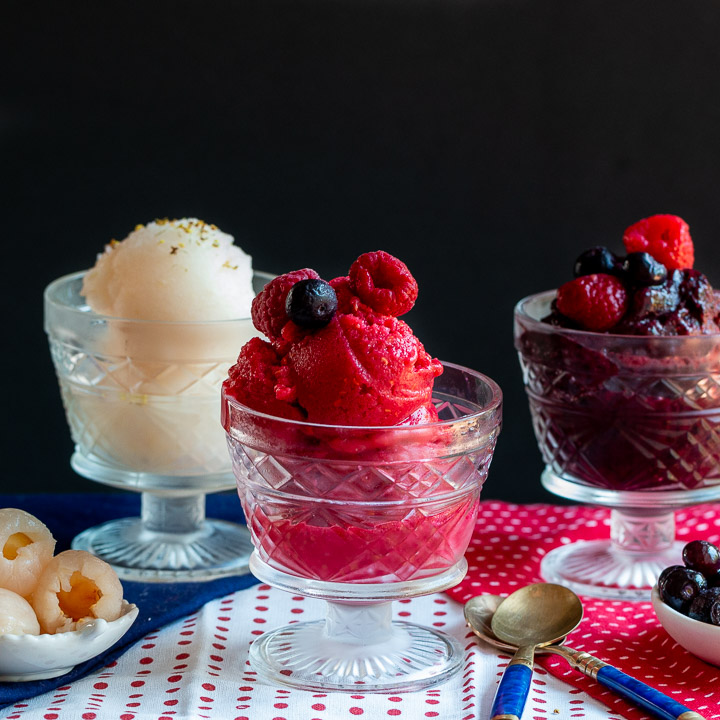 3 healthy sorbets, lychee, raspberry and blueberry in dessert cups.