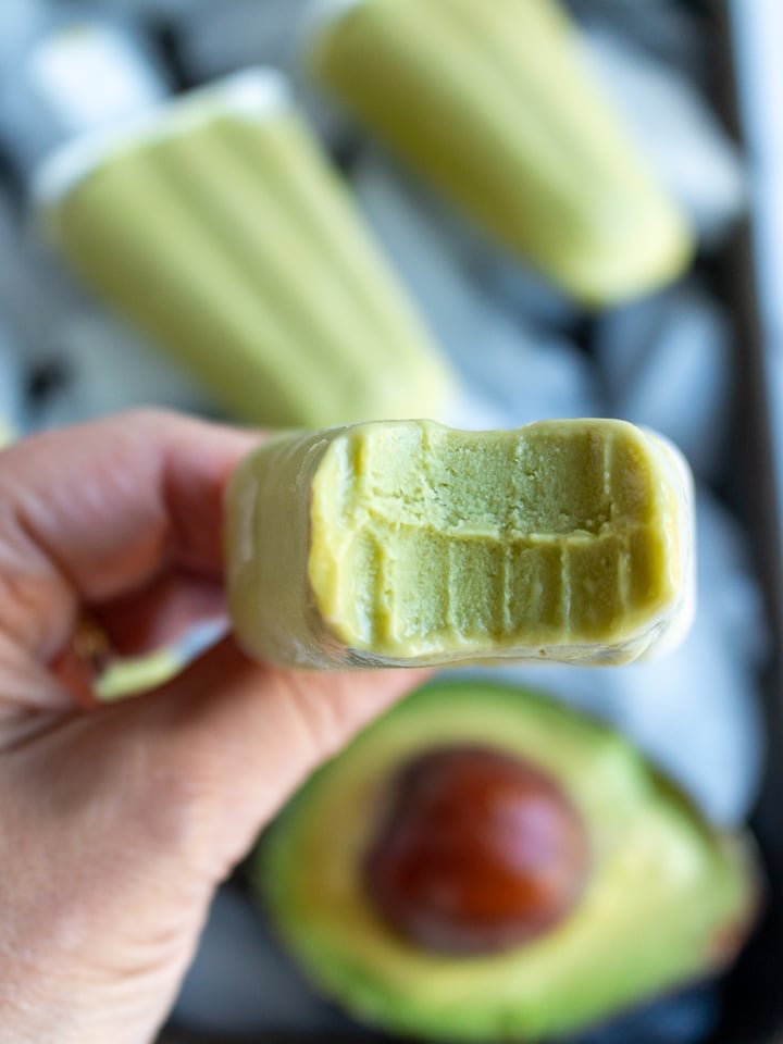 Bite Shot of avocado candy with teeth marks. 