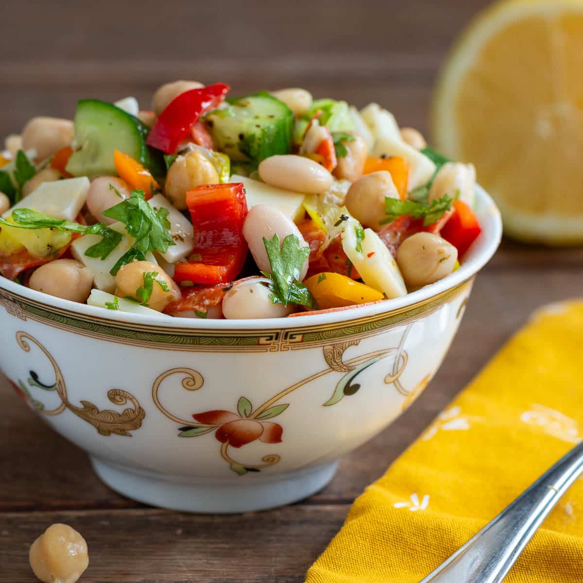 Chopped dense bean salad in white and green bowls. 
