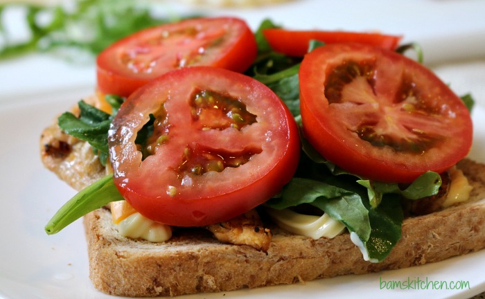 Tomatoes added to the sandwich.