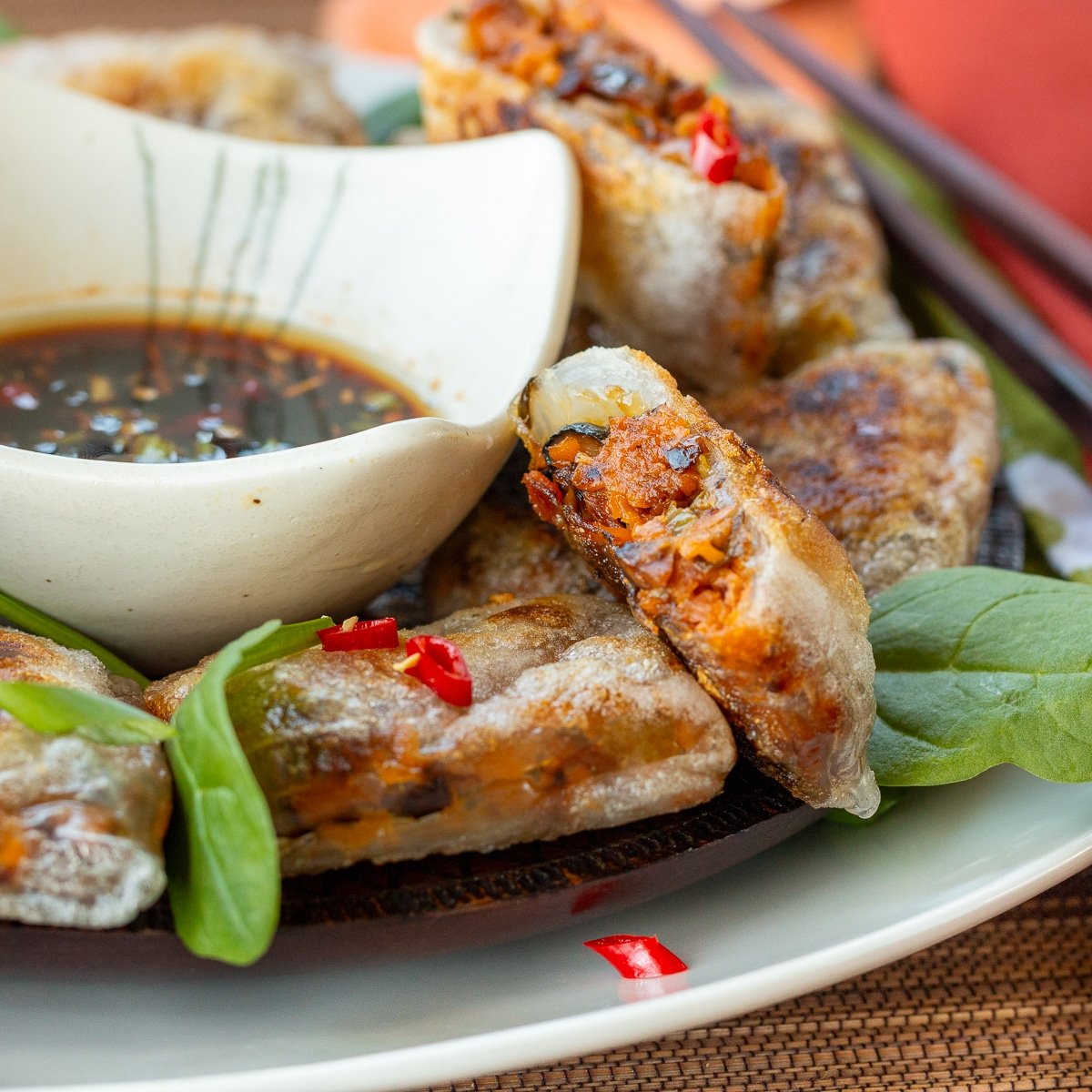 A vegan dumpling cut in half to show the sweet potatoes and mushroom filling. 