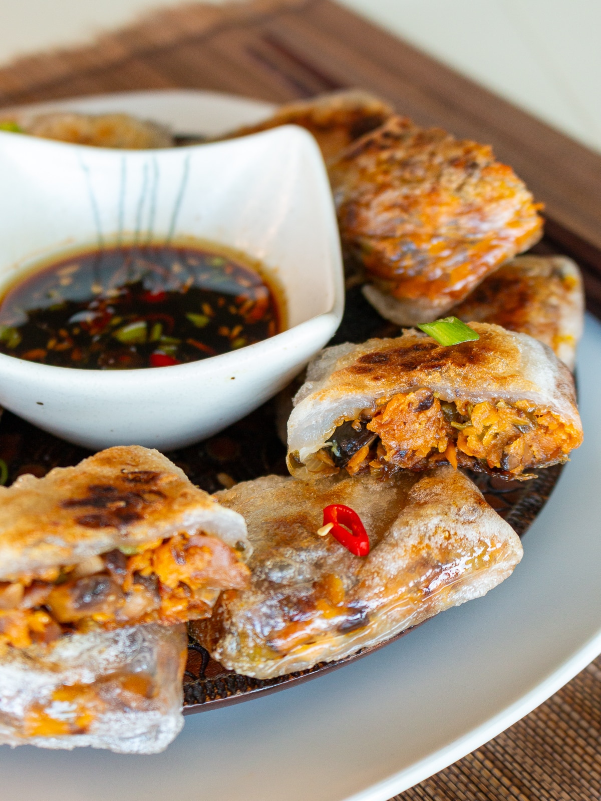 Air fried rice paper dumplings on a wooden plate ready to eat. 