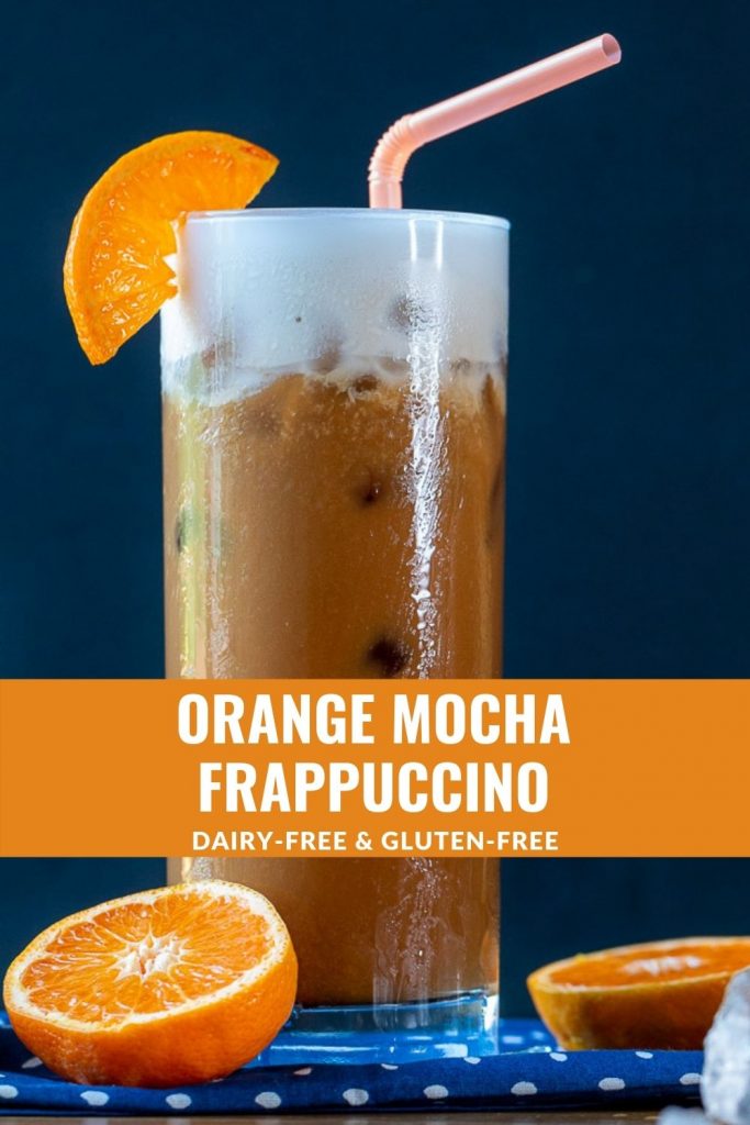 Frothy mixed orange and espresso Frappuccino garnished with fresh oranges.