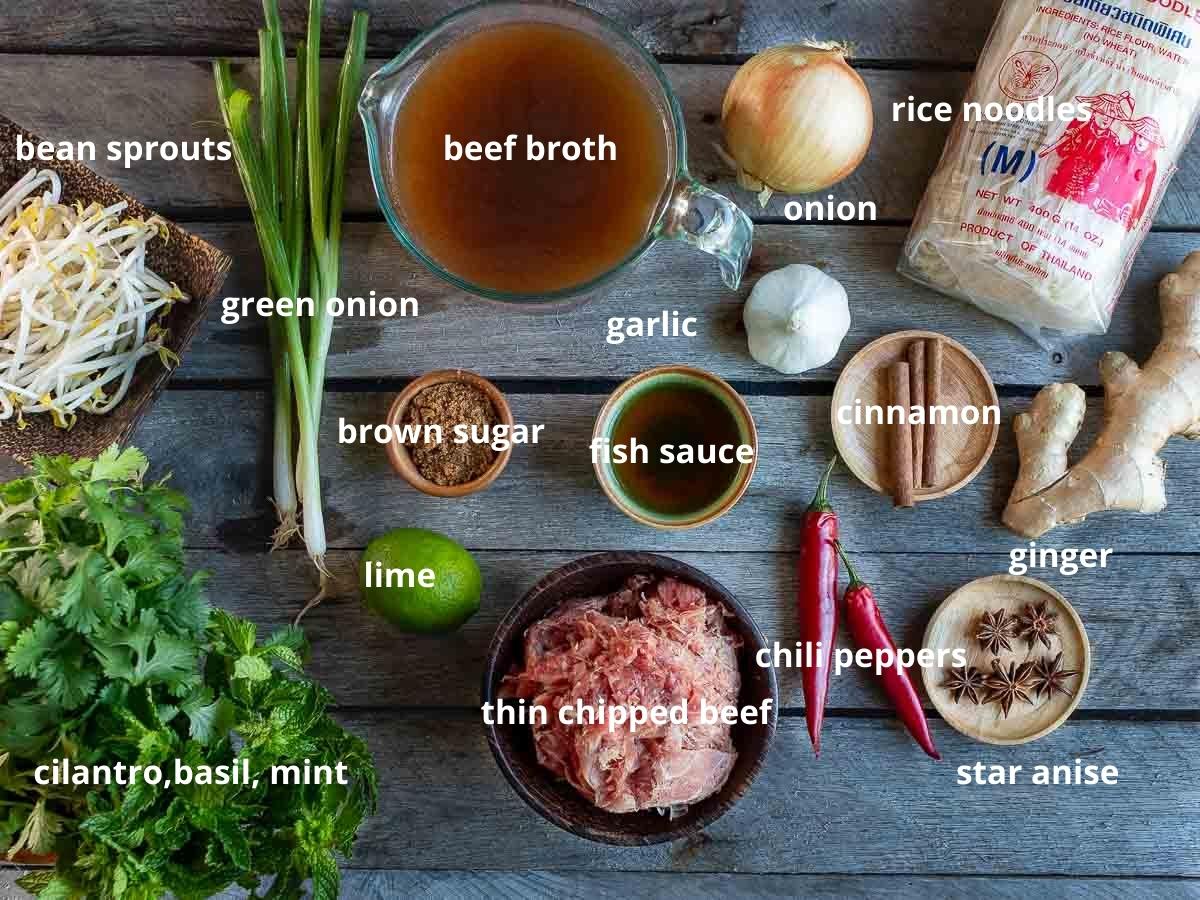 Beef pho ingredients laid out on the table and labeled.