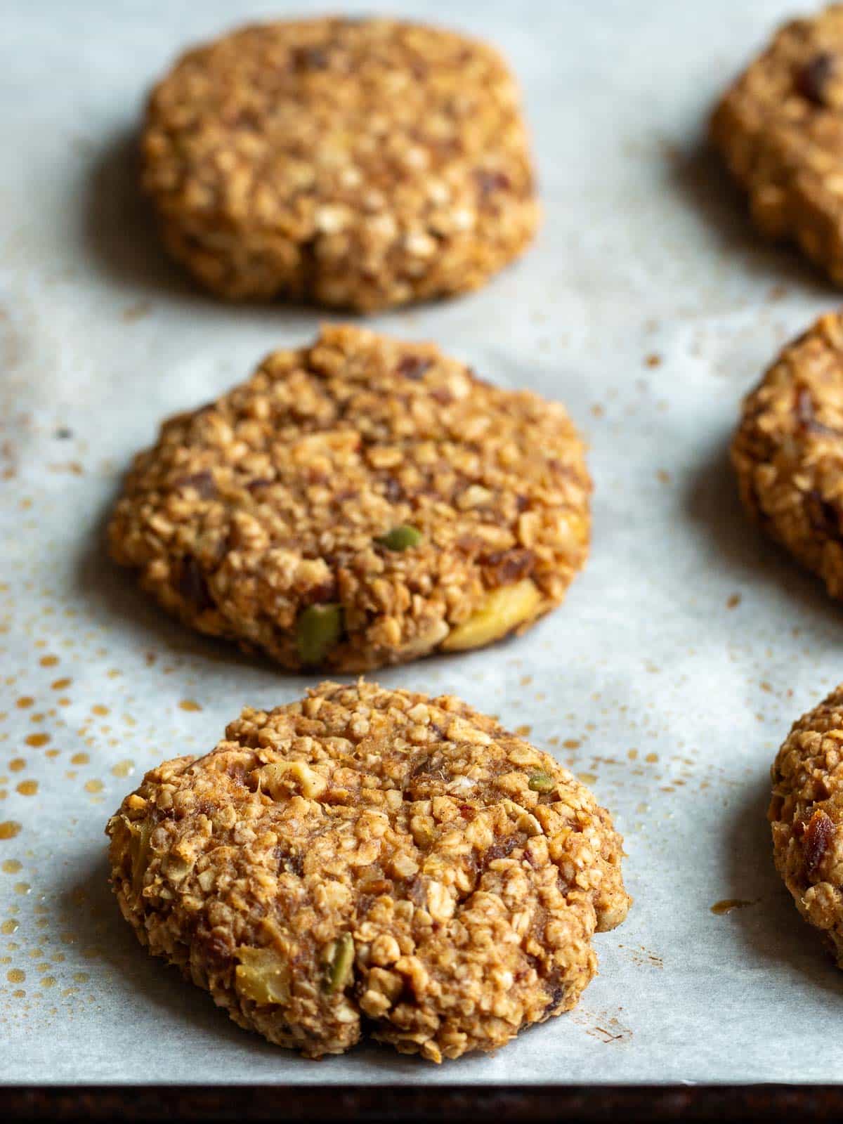 Lightly bronzed baked apple cookies fresh from the oven on the baking sheet. 