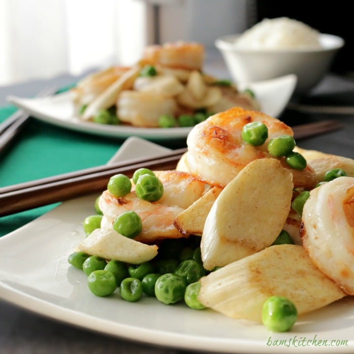 Shrimp and Wild Rice Stem (茭白) Stir Fry on a white Asian plate with chopsticks on the plate.