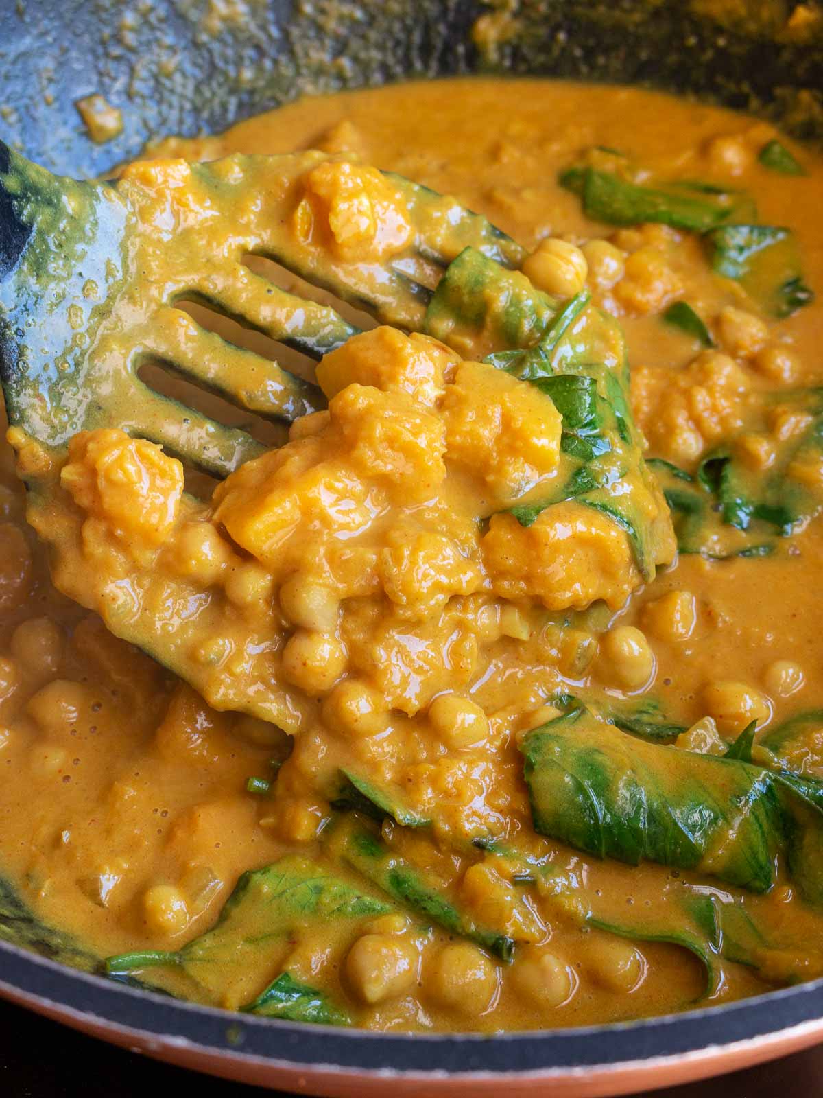 Easy chickpea coconut curry with pumpkin in a wok.