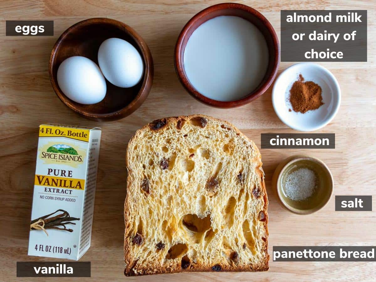 Ingredients to make French toast laid out on a wooden board.