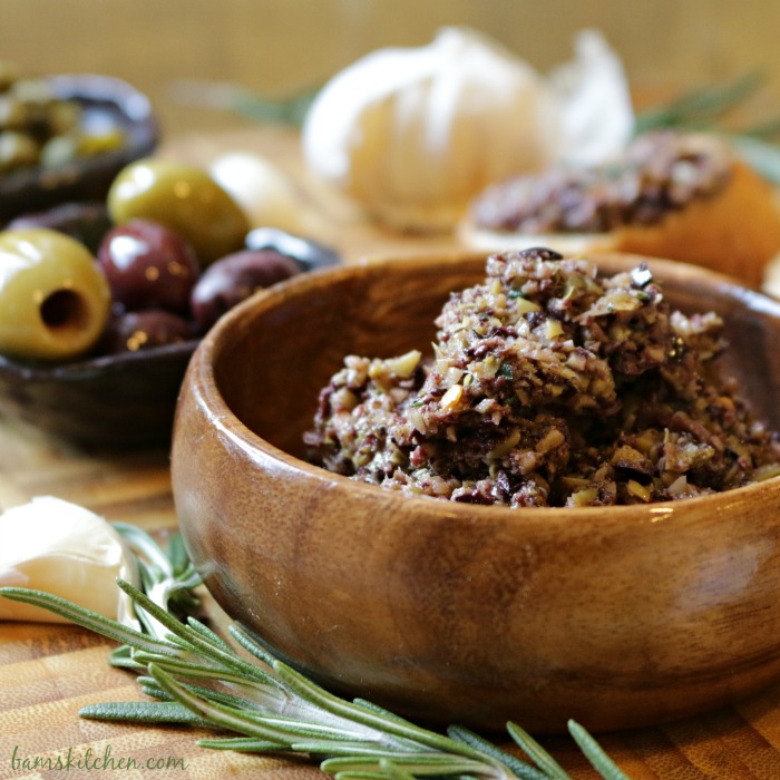 Crushed olive tapenade on a wooden bowl.