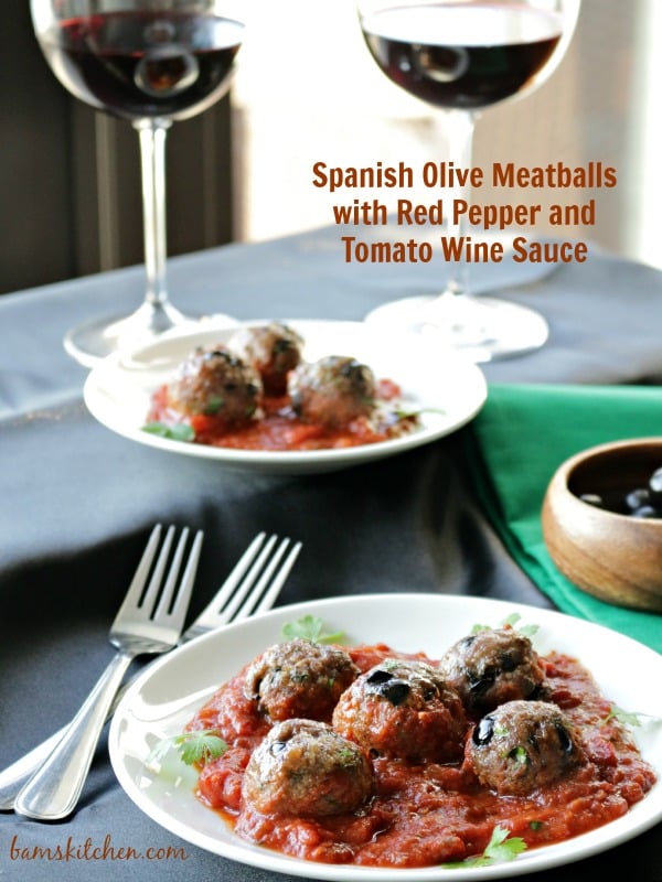 Spanish Olive Meatball served on white plates with red wine.