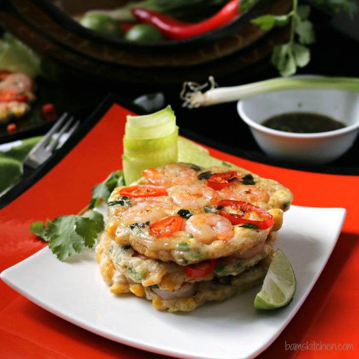 Gluten free Thai Shrimp Pancakes stacked up on a red Asian plate with dipping sauce.