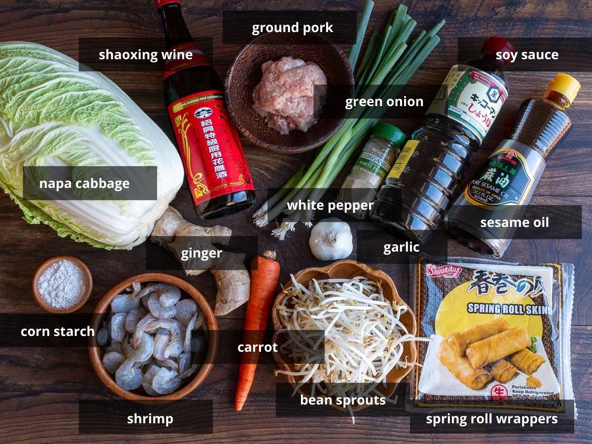 Spring roll ingredients laid out on a wooden board.
