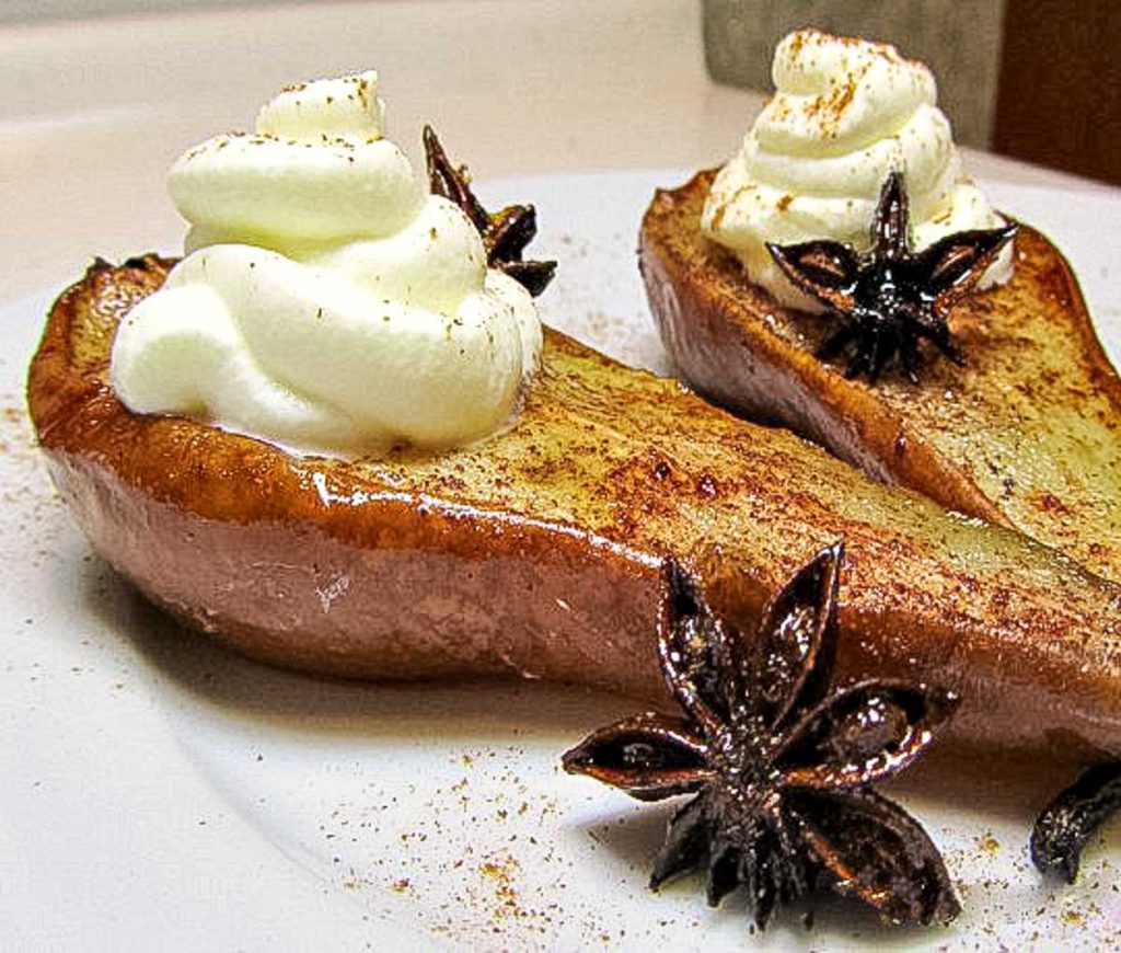 Baked pears with anise and topped with coconut whipped cream