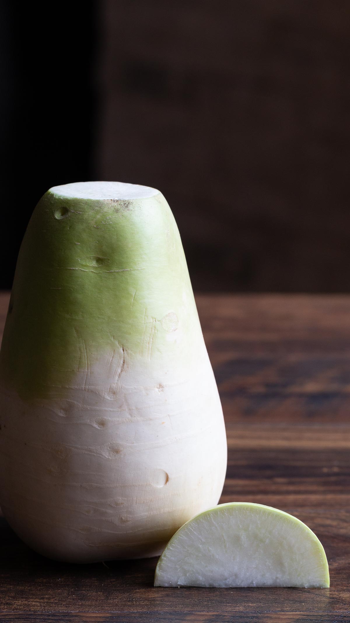 Alpine Daikon standing upright on the wooden board.