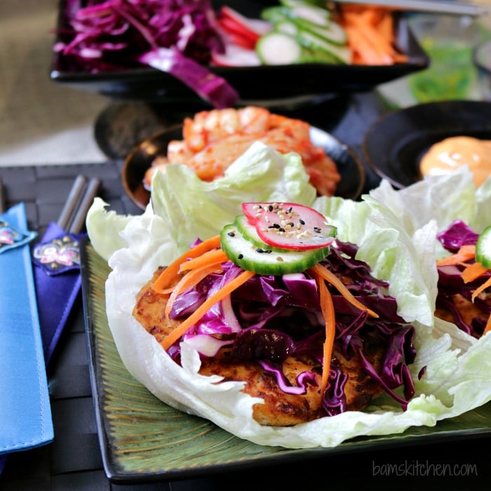 Kimchi Salmon and Quick Pickles on a green plate with metal chopsticks.