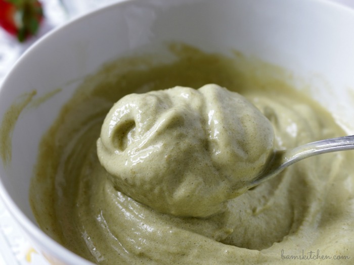 soft serve banana matcha ice cream in a spoon in a white bowl.