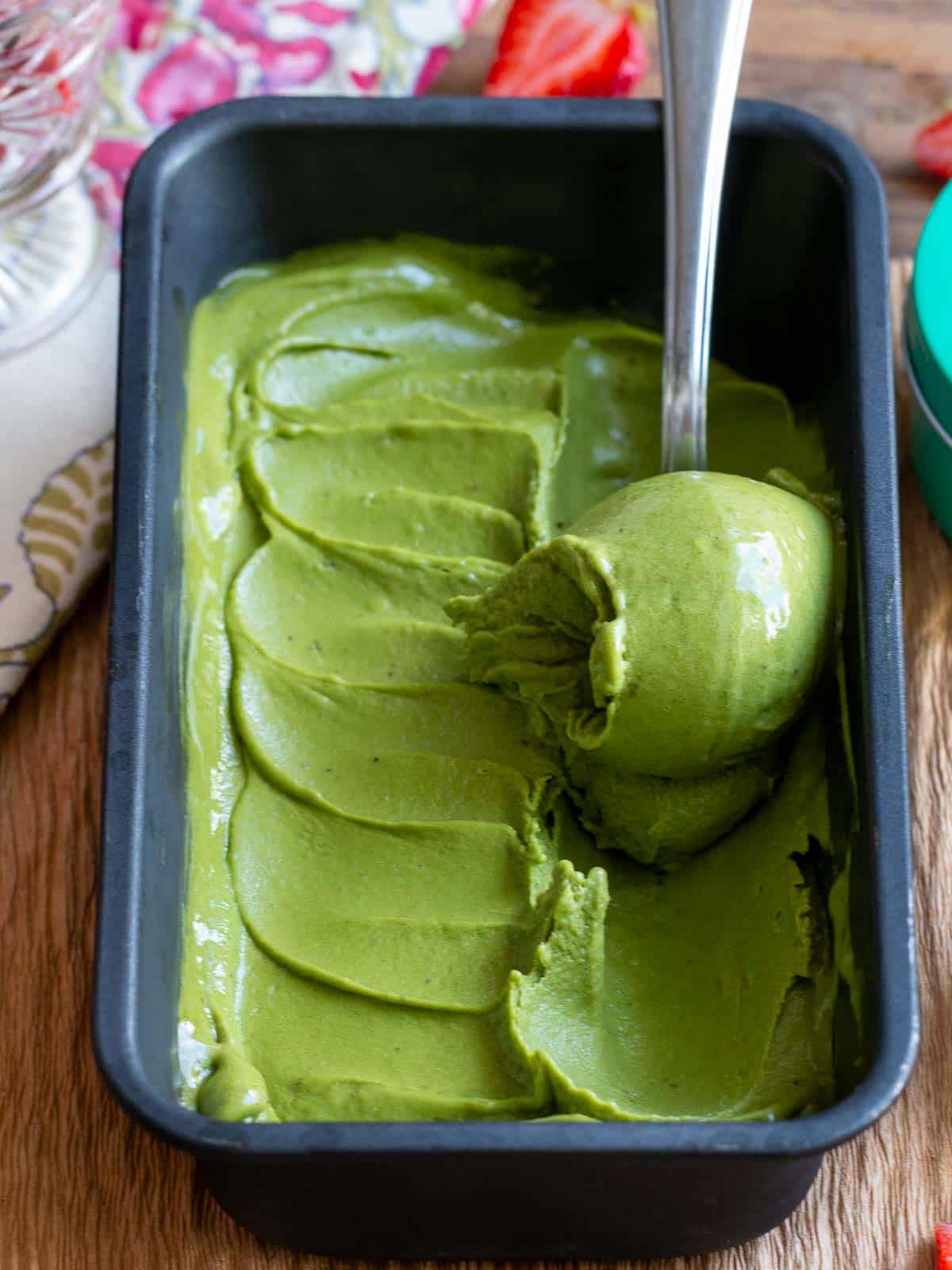 Frozen matcha ice cream getting scooped. 
