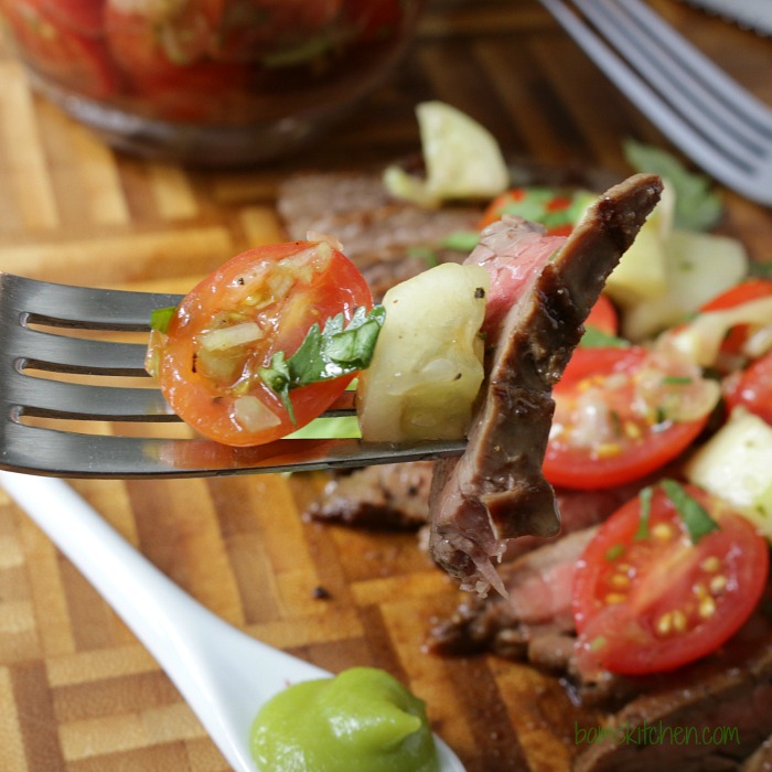 The bite shot with juicy grilled steak and some of the bloody Mary salsa on a fork. 